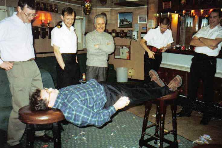 David Doig 
suspended between bar stools 
