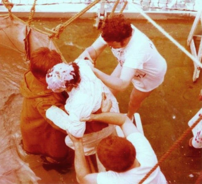 Tarbatness - April 7th, 1977
Geoff Davis (Fridge Eng. in duffle coat), Colin Evans (Eng) and Keith Preston (Purser) helping Hillary Fell into the pool.
